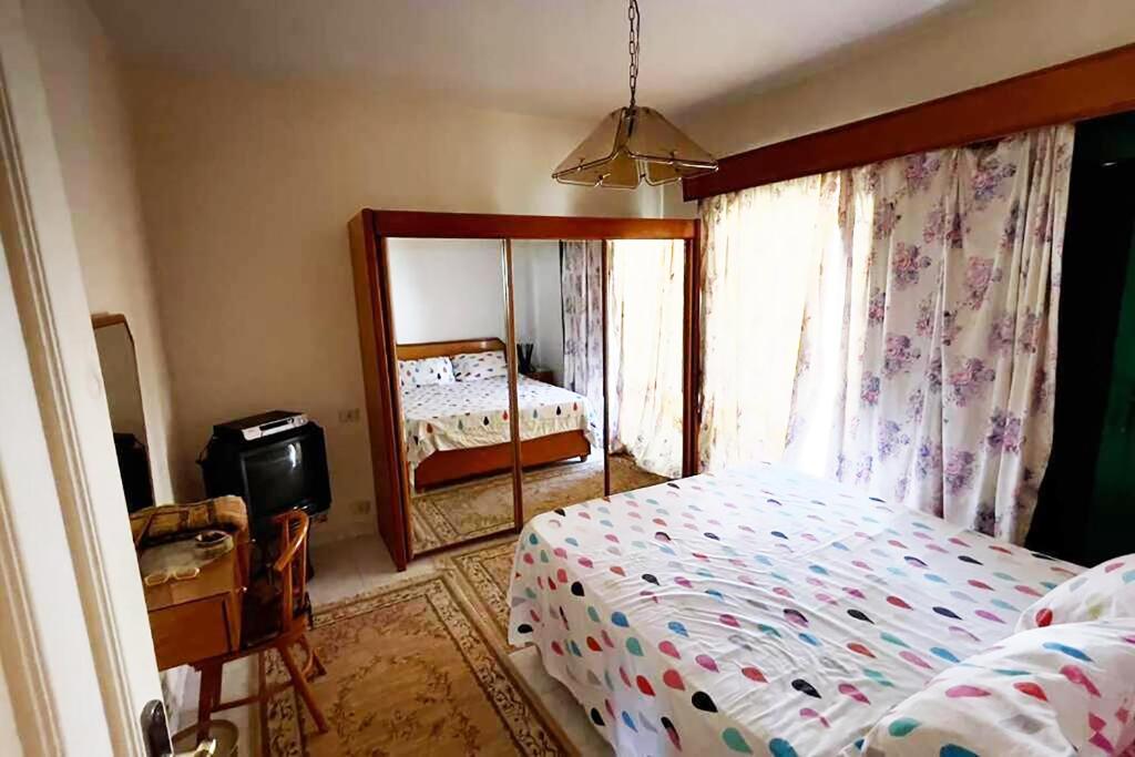 a bedroom with a bed and a large mirror at Concorde Royal Beach Village, Ras Sidr, South Sinai Villa 116 in Ras Sedr