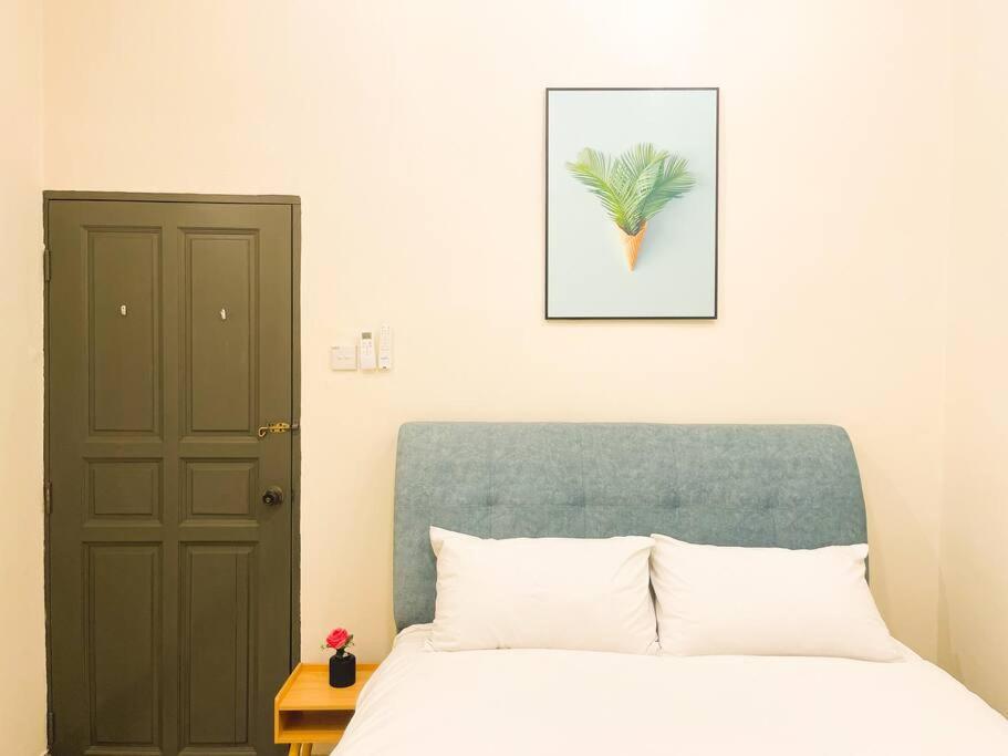 a bedroom with a bed and a picture of a pineapple at Southkey Mid Valley , Karaoke, Table Football in Johor Bahru