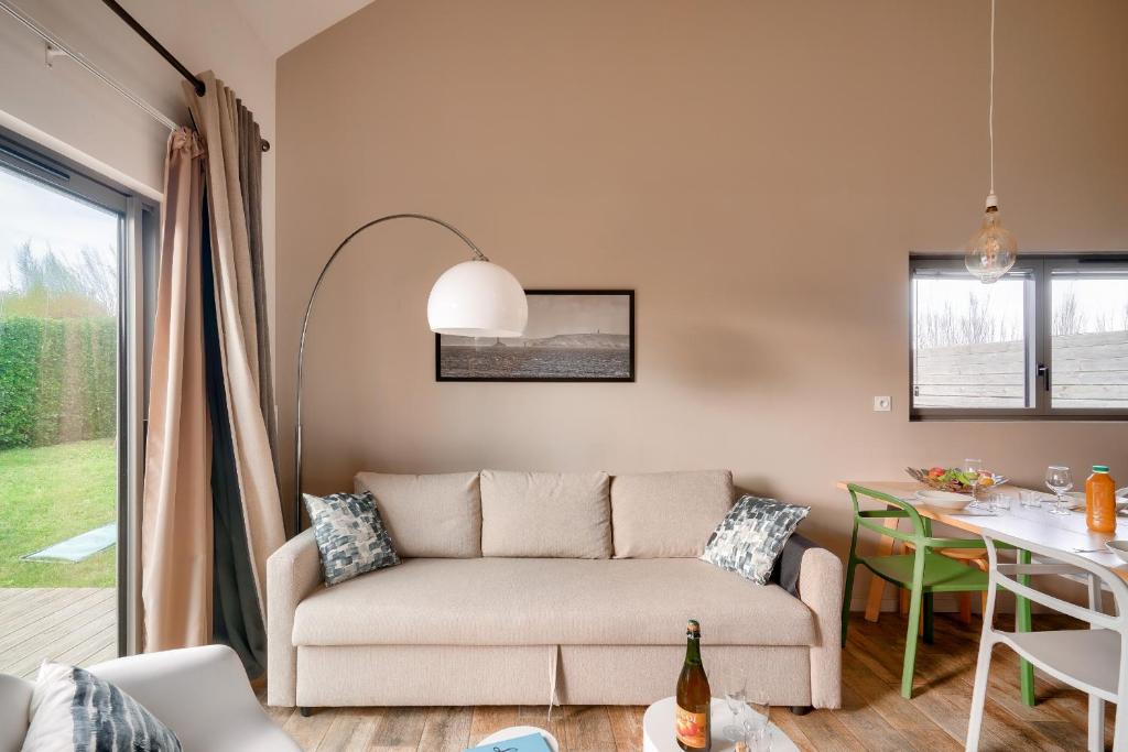 un salon avec un canapé et une table dans l'établissement Duplex à 100m de la plage de Pors Carn - Surf, à Penmarcʼh