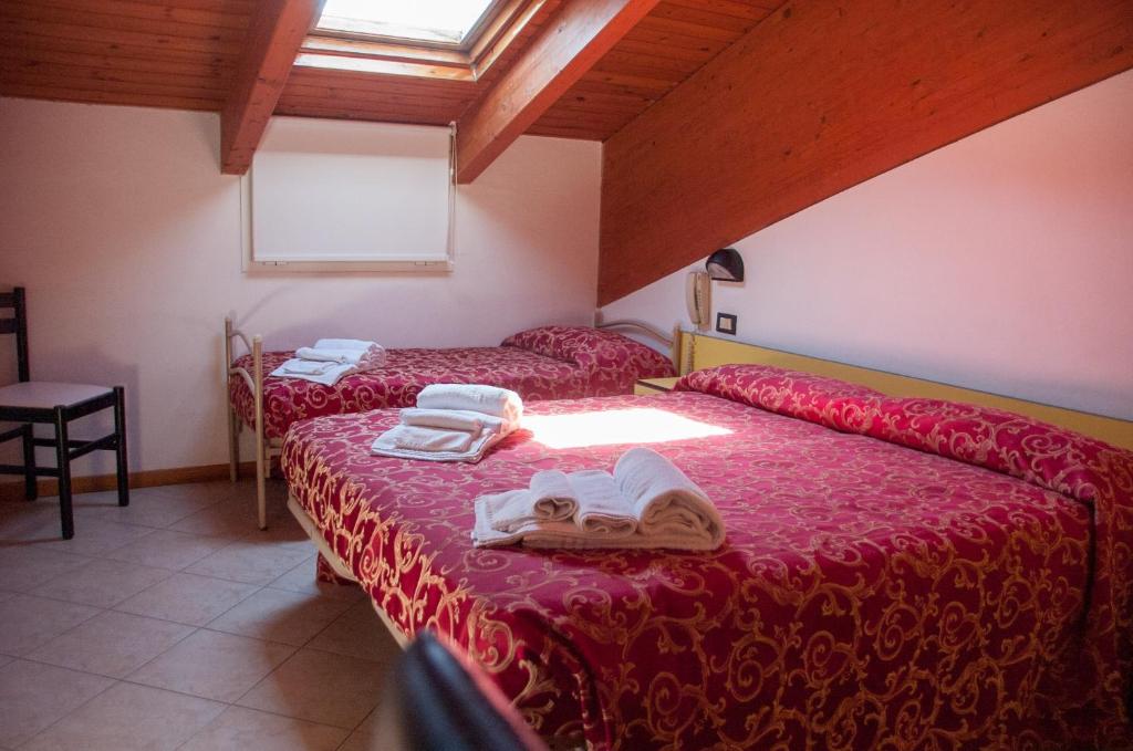 Postel nebo postele na pokoji v ubytování Albergo Villa Miraggio