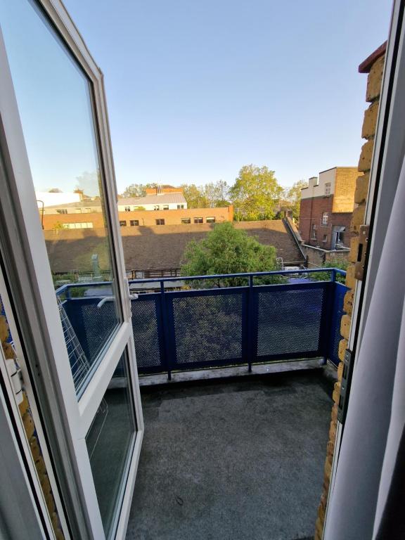 a balcony with an open window and a view at Spacious room private balcony - Central London - zone 1 - Elephant and Castle in London