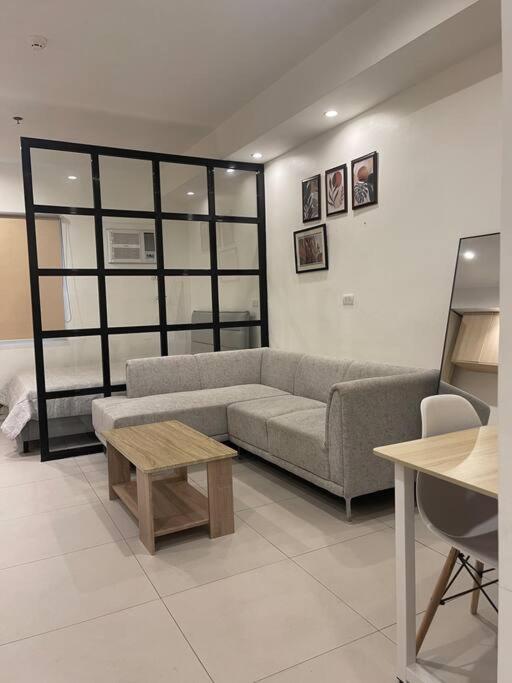 a living room with a couch and a table at Studio unit in Prime Location in Davao City