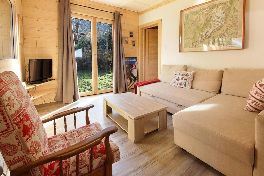 a living room with a couch and a table at Le Petite Chalet Tourmente in Chamonix-Mont-Blanc