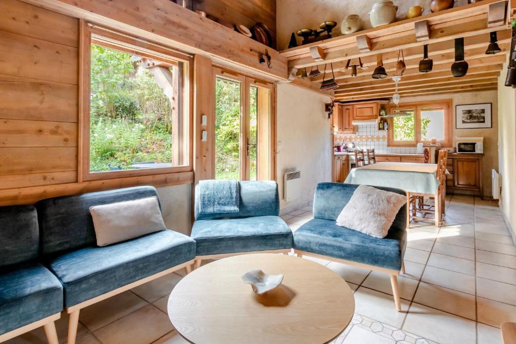 a living room with blue couches and a table at Les Cristalliers - Cozy family chalet - Close to the village in Les Houches