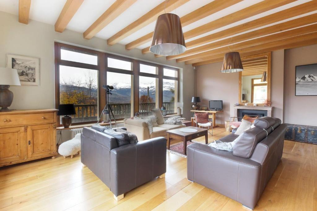 a living room with two couches and a tv at Saint Éloi - Panoramic view - Mont Joly - Central in Saint-Gervais-les-Bains