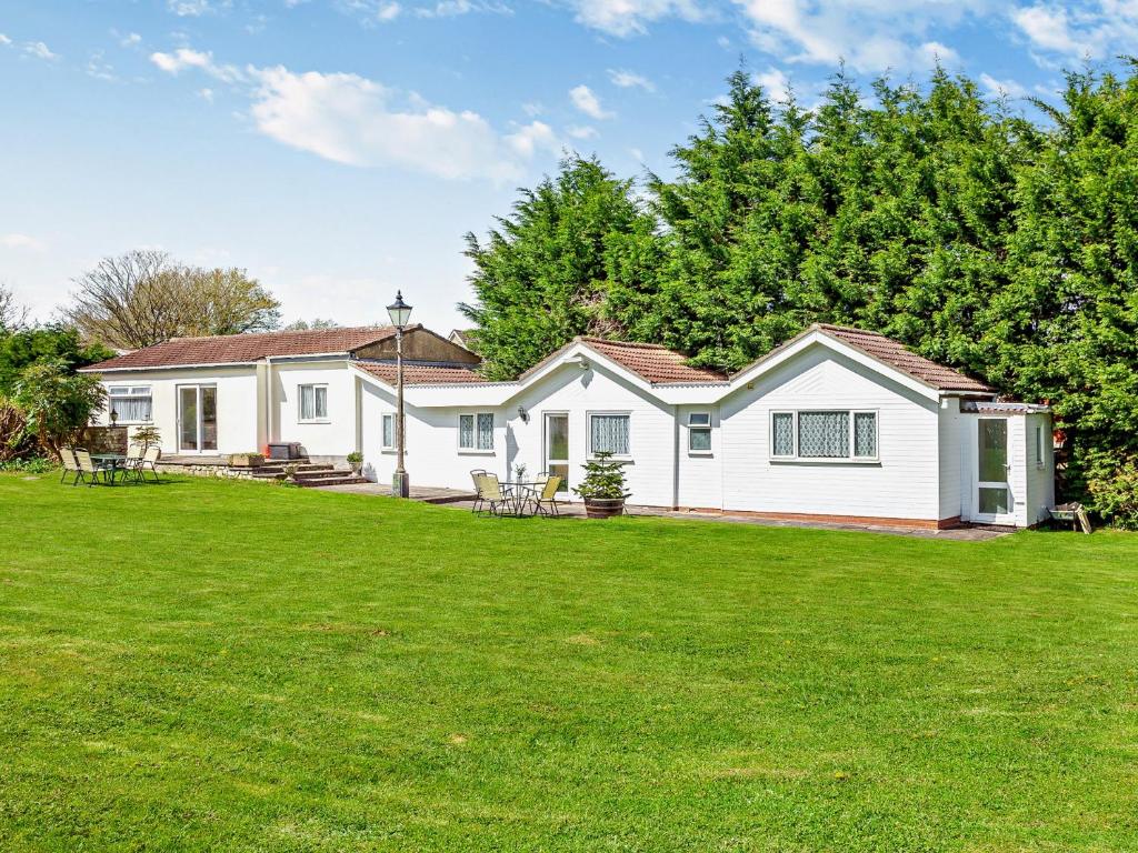 a white house with a lawn in front of it at 2 bed in Bath 05135 in Chew Magna