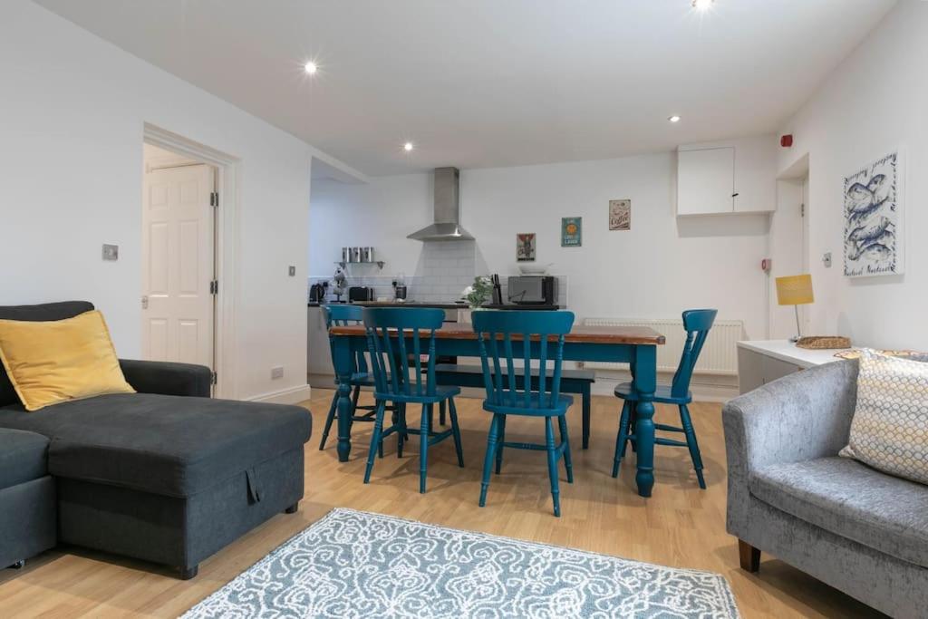 a living room with a table and chairs and a couch at Ethlebert Motel; in Margate