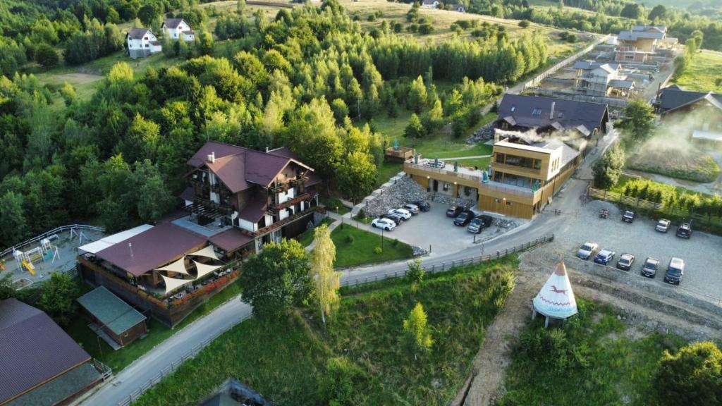 an aerial view of a large house with a yard at Maggie's Ranch in Râşnov