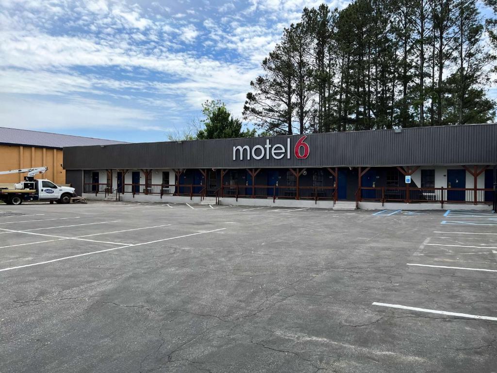 a mola building with a parking lot in front of it at Motel 6 Cordele, GA in Cordele