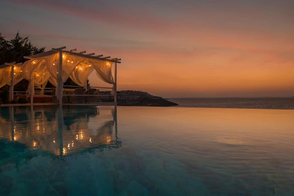 a wedding tent on the water at sunset at BEACH FRONT SUPER VİLLA Boss 2 in Bodrum City