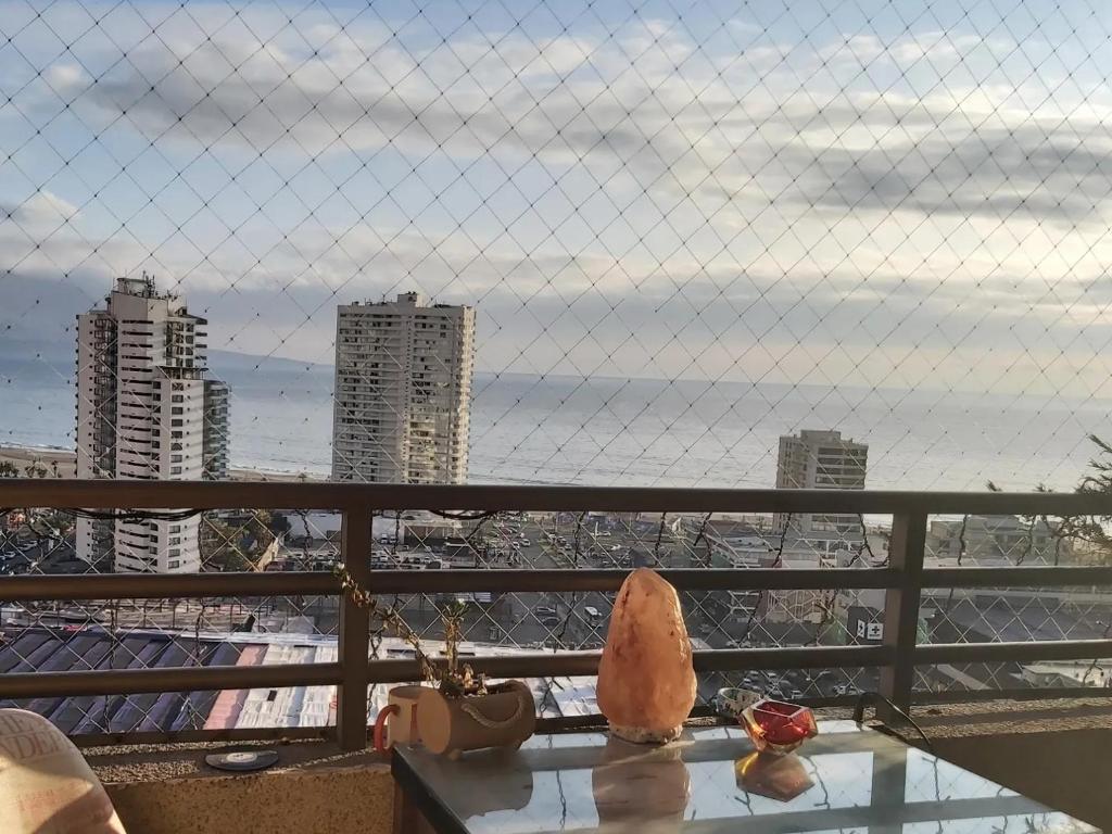 a table on a balcony with a view of a city at Habitación frente al mar in Iquique