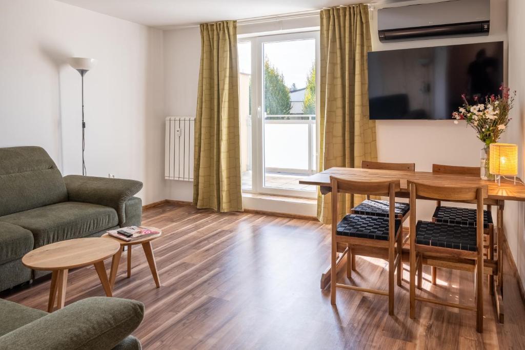 a living room with a couch and a table at Sunny apartment in Trnava in Trnava