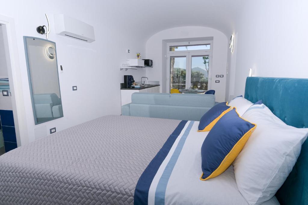 une chambre avec un lit avec des oreillers bleus et blancs dans l'établissement Tenuta monte di Panza, à Ischia