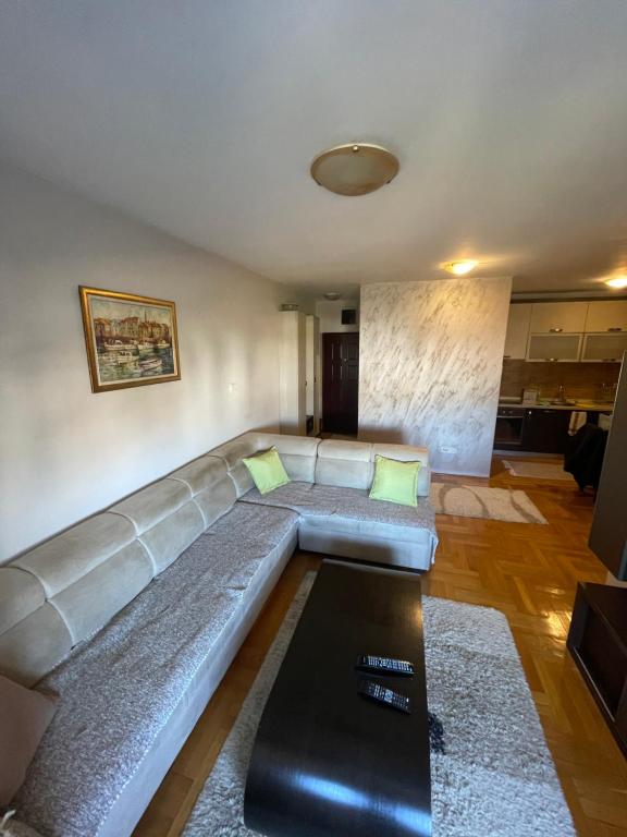 a living room with a couch and a table at One bedroom apartment in urban area in Podgorica