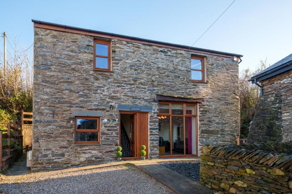a stone house with a stone facade at Farm Cottage - Kirkby-In-Furness, ideal for the Central Lake District in Soutergate