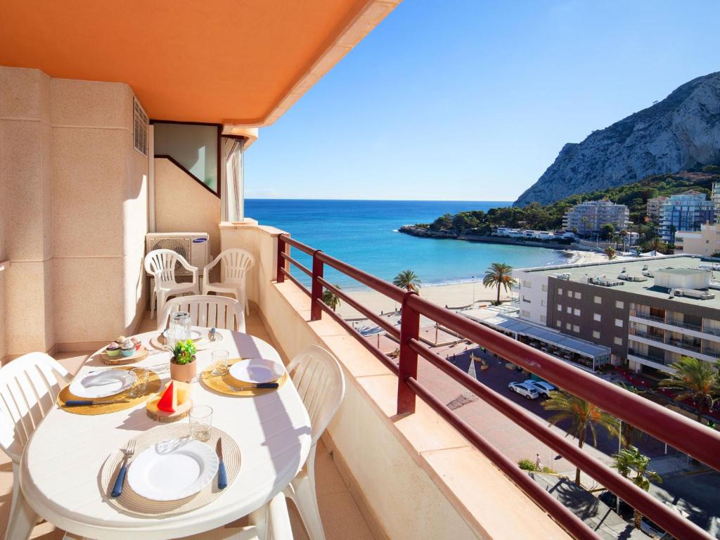 a balcony with a table and chairs and the ocean at Apartment Zafiro 02 by Interhome in Calpe