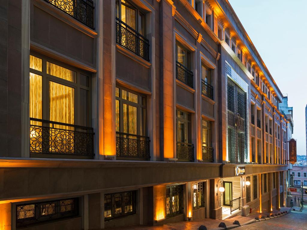 a large building with many windows on a street at Manesol Boutique Galata in Istanbul