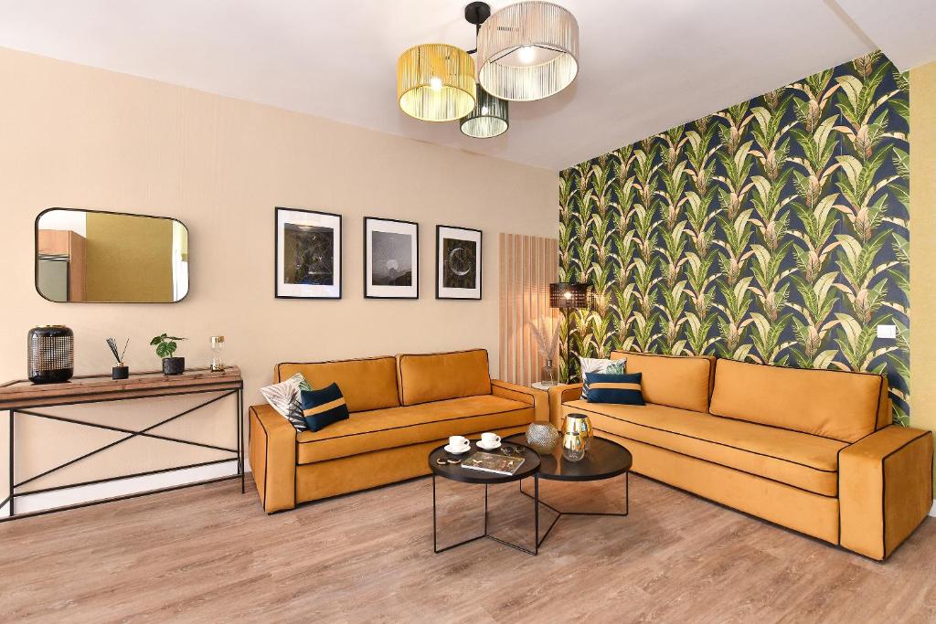 a living room with two couches and a table at Apartamento Deluxe en Cruce de Arinaga GRANEL in Cruce de Arinaga