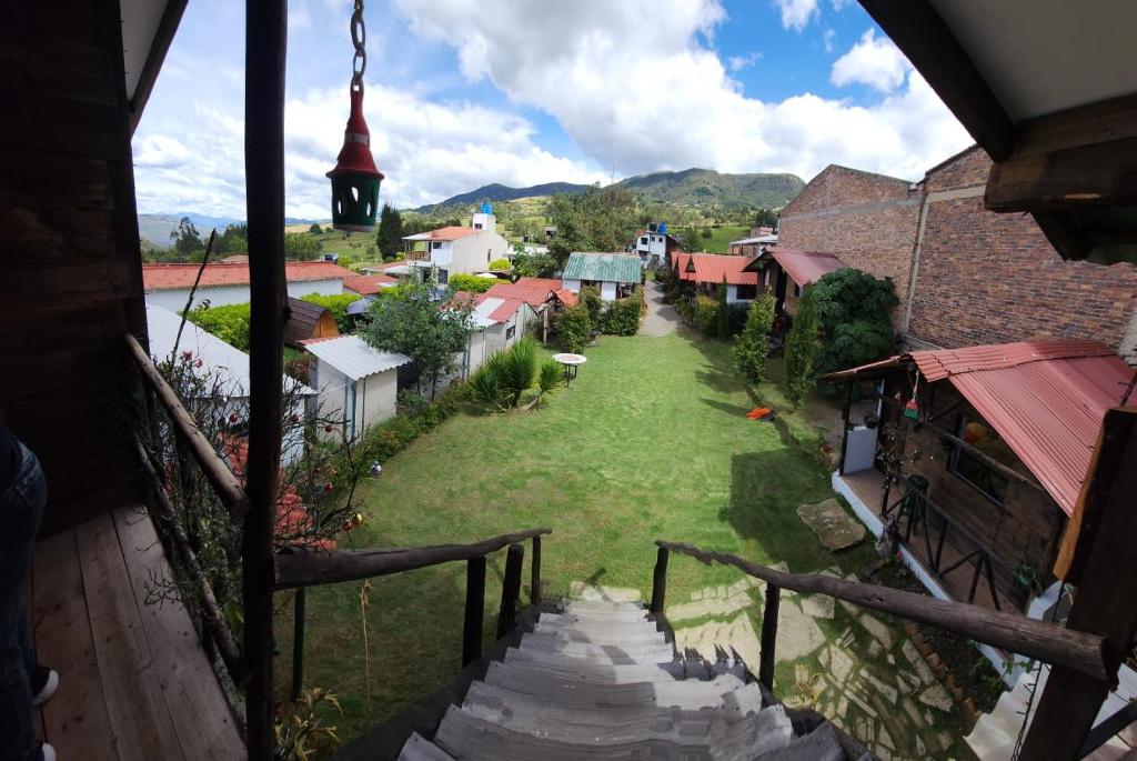 a view from a balcony of a village with a church at Hospedaje Las Cabañas in Monguí