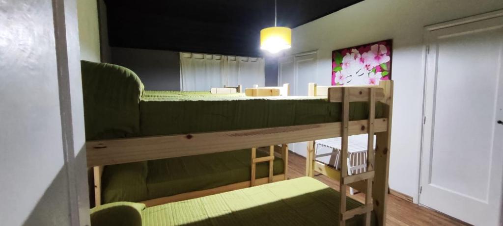 a room with two bunk beds and a table at Hostel Tandil in Tandil