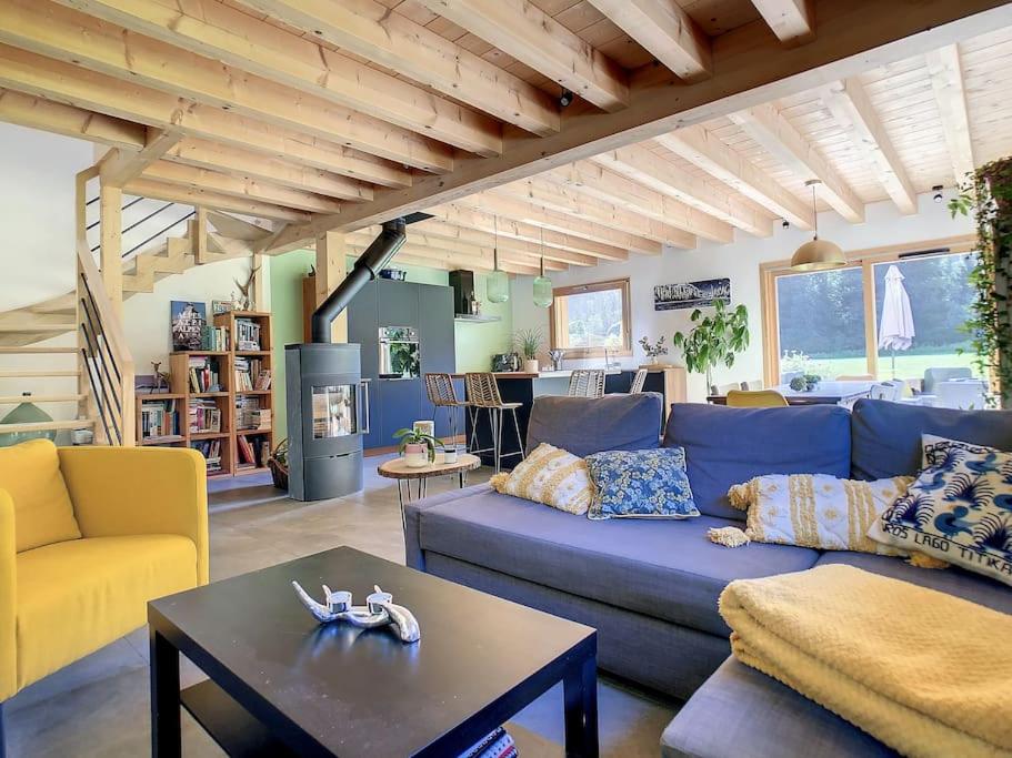 a living room with a blue couch and a table at Le Vivier in Saint-Gervais-les-Bains