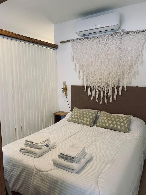 a bedroom with a bed with towels on it at Complejo Sol - Departamento 4 in Concordia