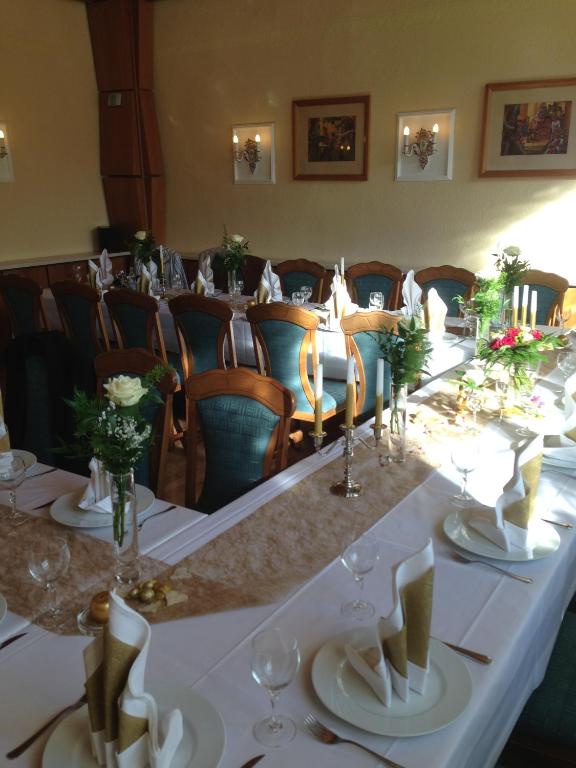 a long table in a room with chairs at Hotel Am Schlossberg in Ziegenrück