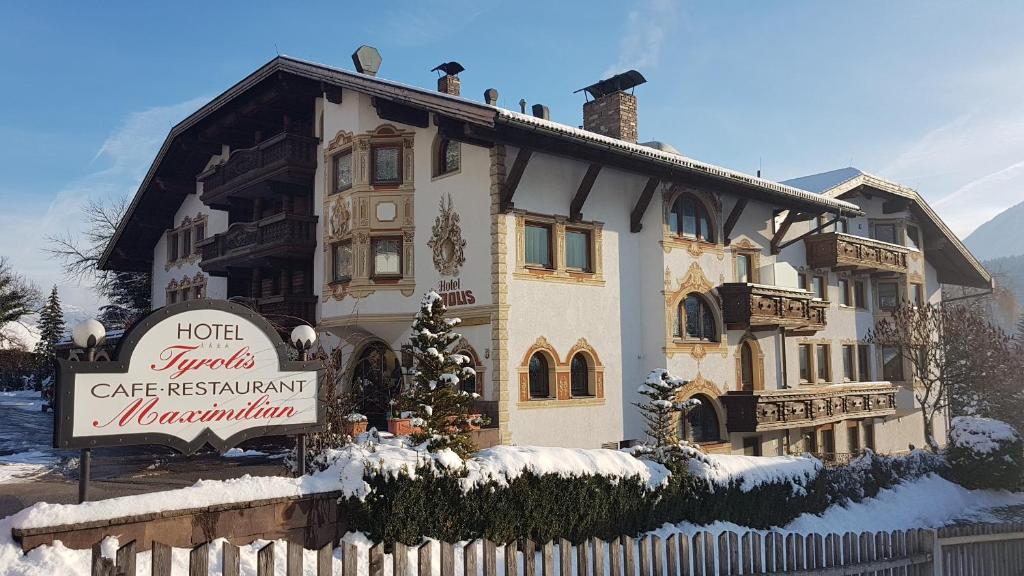 a large house with a sign in front of it at Hotel Tyrolis in Zirl