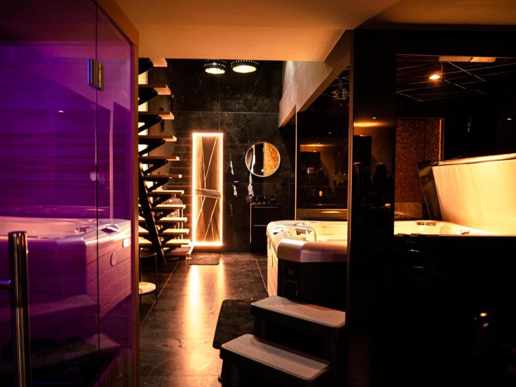 a bathroom with two sinks and a wine cellar at Douceur du Charme - Love-room à Charmes entre Epinal et nancy in Charmes