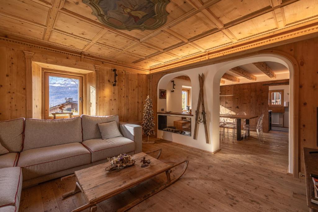 a living room with a couch and a table at Casa Alvera Dream in Cortina dʼAmpezzo