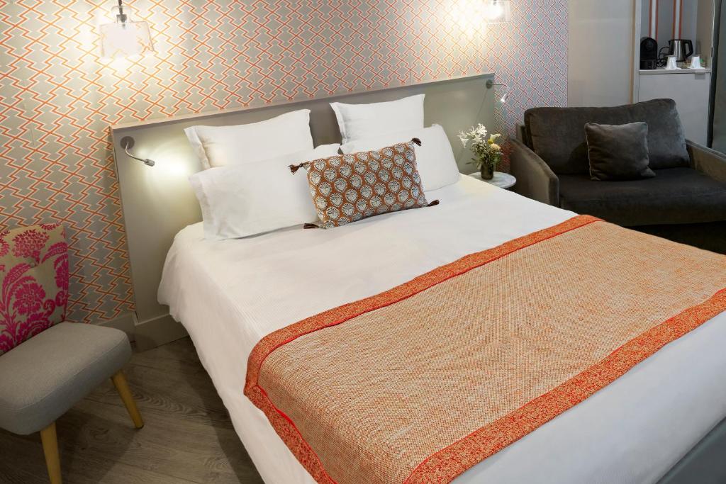 Postel nebo postele na pokoji v ubytování Hôtel Vic Eiffel