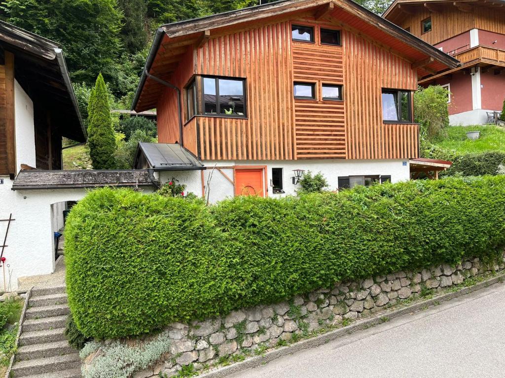 a house with a stone wall in front of it at Bergsteigerzimmer Doktorberg in Berchtesgaden