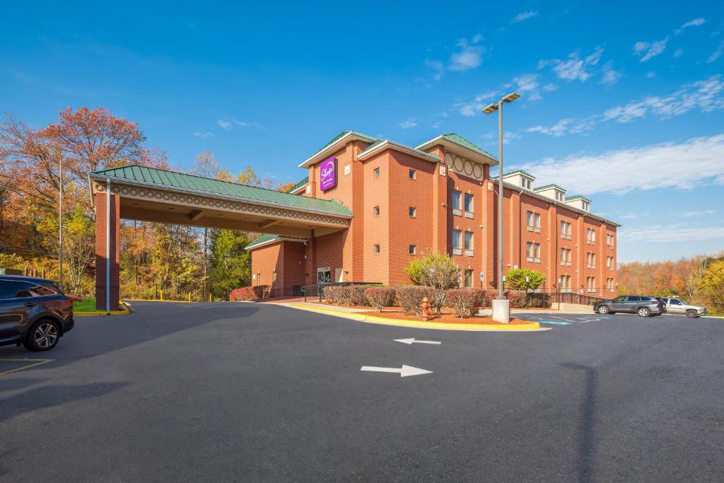 a building with a parking lot in front of it at Sleep Inn & Suites near Joint Base Andrews-Washington Area in Morningside