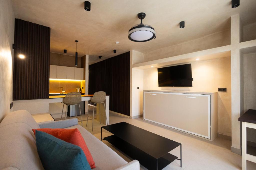 a living room with a couch and a table at Apartamentos Playazul in Playa de las Americas