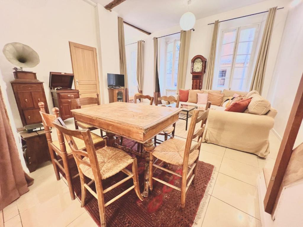 a living room with a wooden table and chairs at ApartHotel Riviera - CCC OT Loft du Chateau Old Town Prom des Anglais in Nice