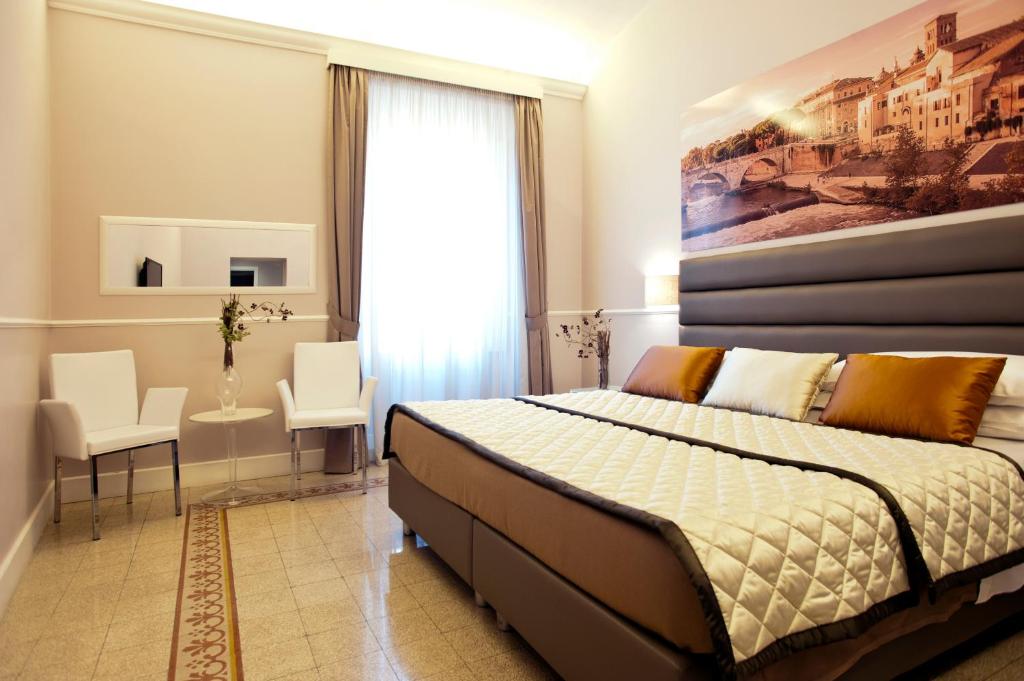 a bedroom with a bed and two chairs and a window at Daplace - La Mongolfiera Rooms in Navona in Rome