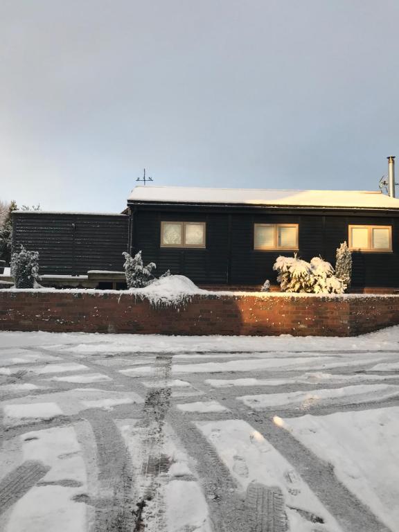 a snow covered parking lot in front of a building at The Stable in Stourbridge