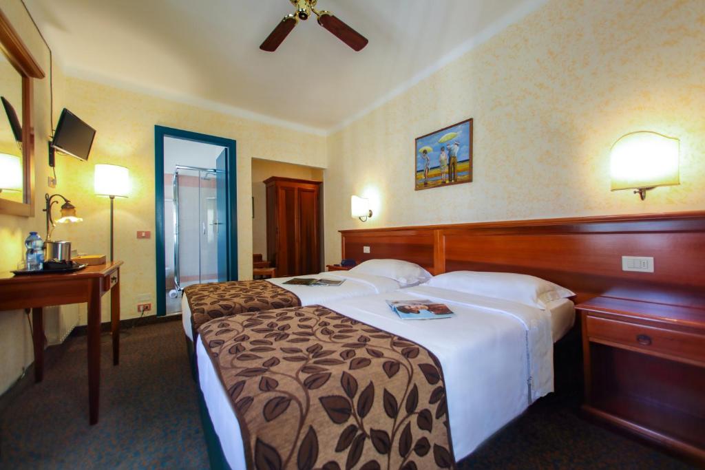 Postel nebo postele na pokoji v ubytování Hotel Garnì Riviera