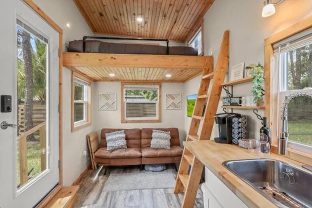 a tiny house with a couch in a kitchen at Tiny House hosted by Joe in West Palm Beach