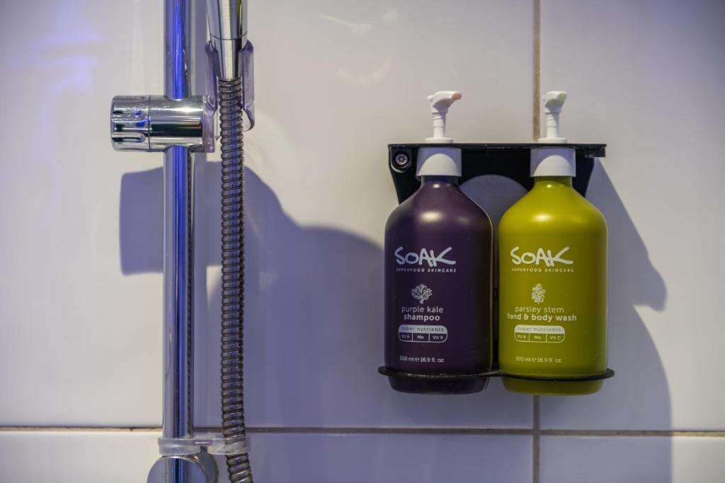 two bottles of soap on a shelf in a bathroom at Holiday Inn Express Ramsgate – Minster by IHG in Minster