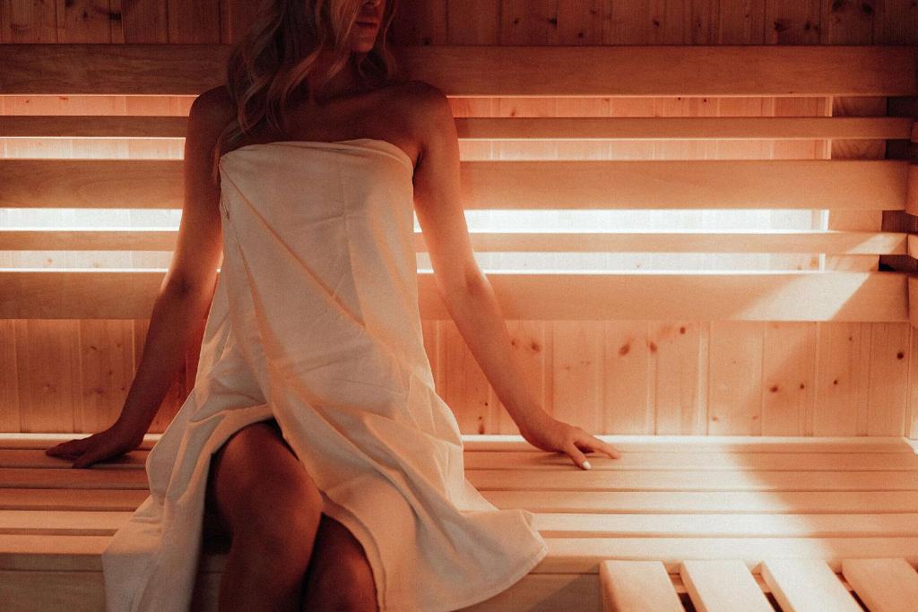 a woman is sitting in a sauna at Luxury BNB - Halifax Rooftop in Halifax