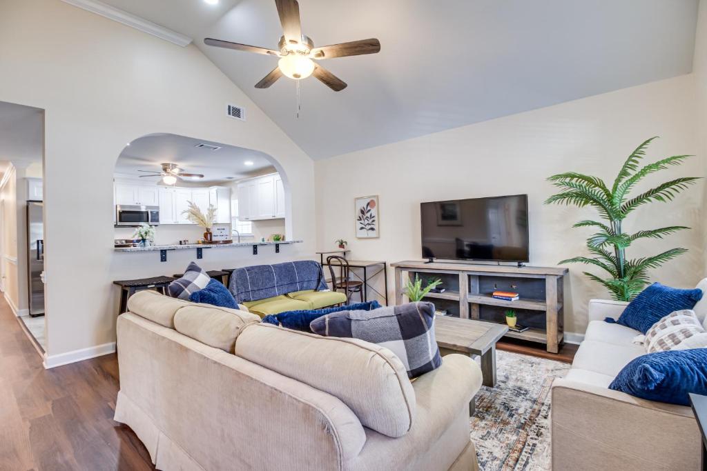 a living room with couches and a ceiling fan at Family Home Near Downtown and Convention Center! in Savannah