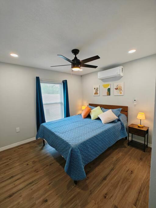 a bedroom with a bed and a ceiling fan at Lovely unit central location in St Petersburg