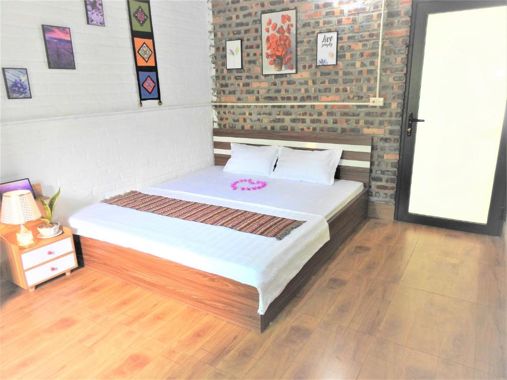 a small bedroom with a bed with white sheets at Homestay Happy Home Sóc Sơn in Hanoi