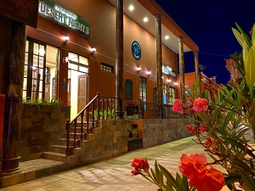 a building with stairs in front of it at night at Desert Nights Hostel in Ica