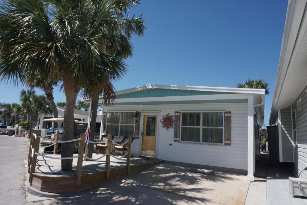a house with a palm tree in front of it at Venture Out 41 Gulf Loop 2bd 1ba WITH GOLF CART in Panama City Beach