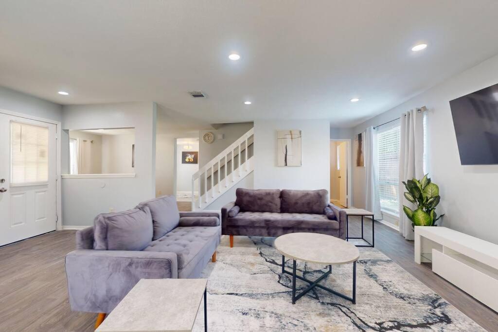a living room with a couch and a table at Entire 3/2.5 Lux Retreat Home in the heart of Houston few Miles from Major Houston attractions & Pets Friendly in Houston