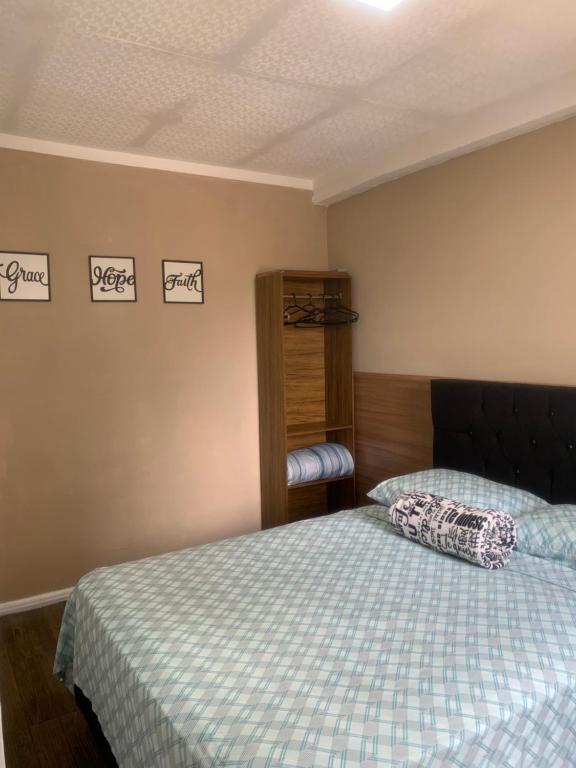 a bedroom with a bed with a blue and white comforter at Casa na Quadra do Mar Praia Brava in Balneário Camboriú