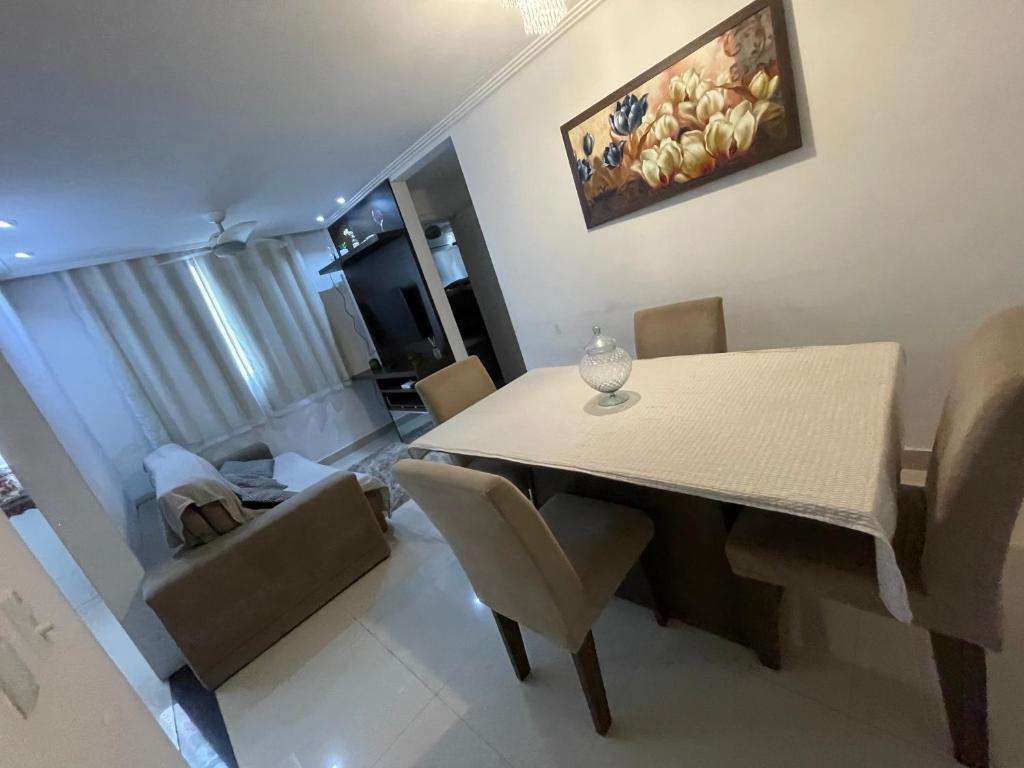 a living room with a dining room table and a couch at Água Campos in Campos dos Goytacazes