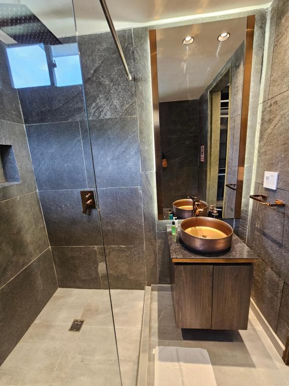 a bathroom with two sinks and a shower at La casa en el aire in Medellín